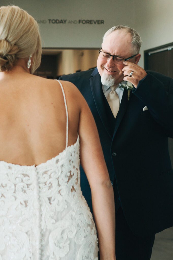 dad wipes away tears after seeing his daughter in wedding dress for first time
