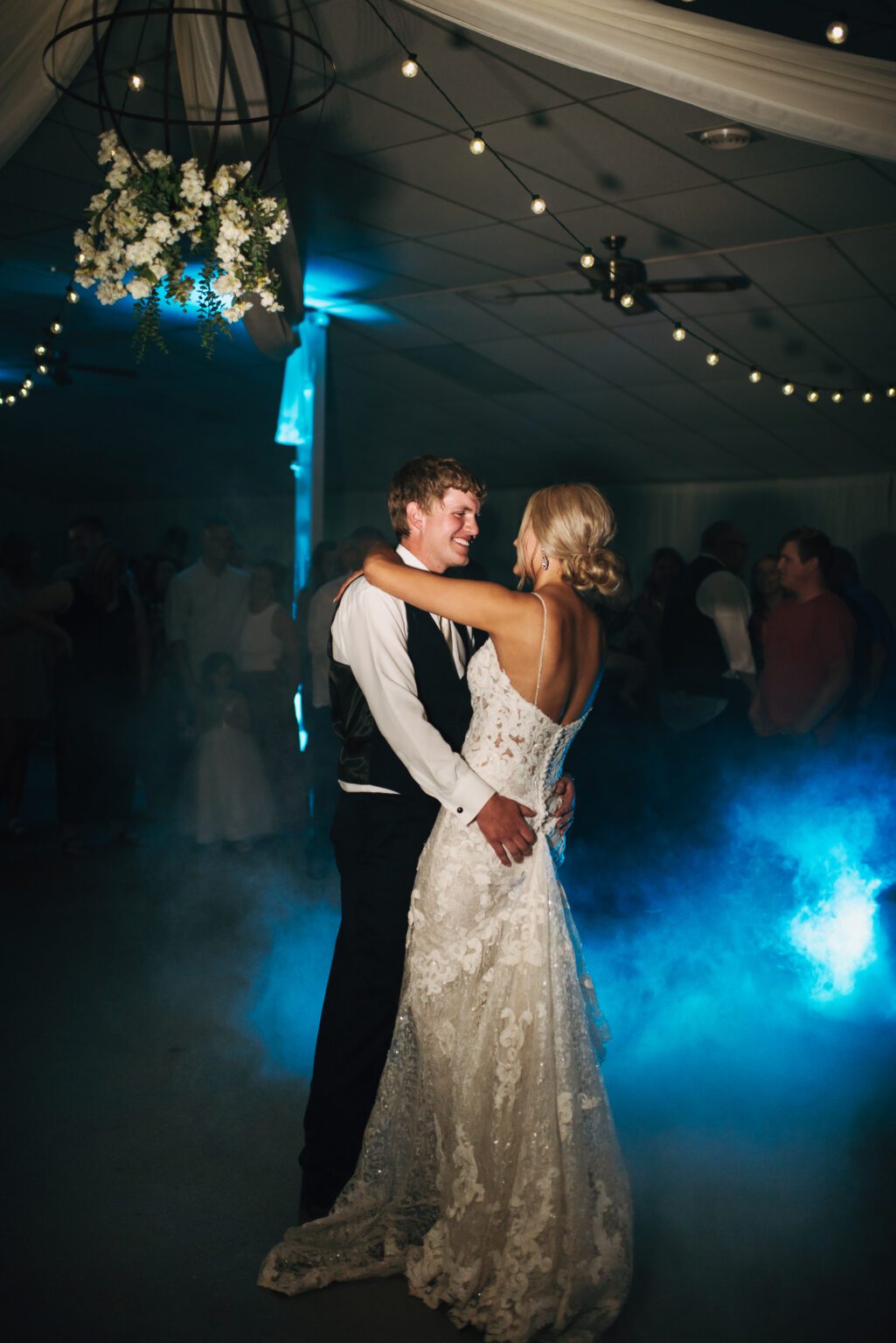 first dance with bride and groom while blue fog surrounds them