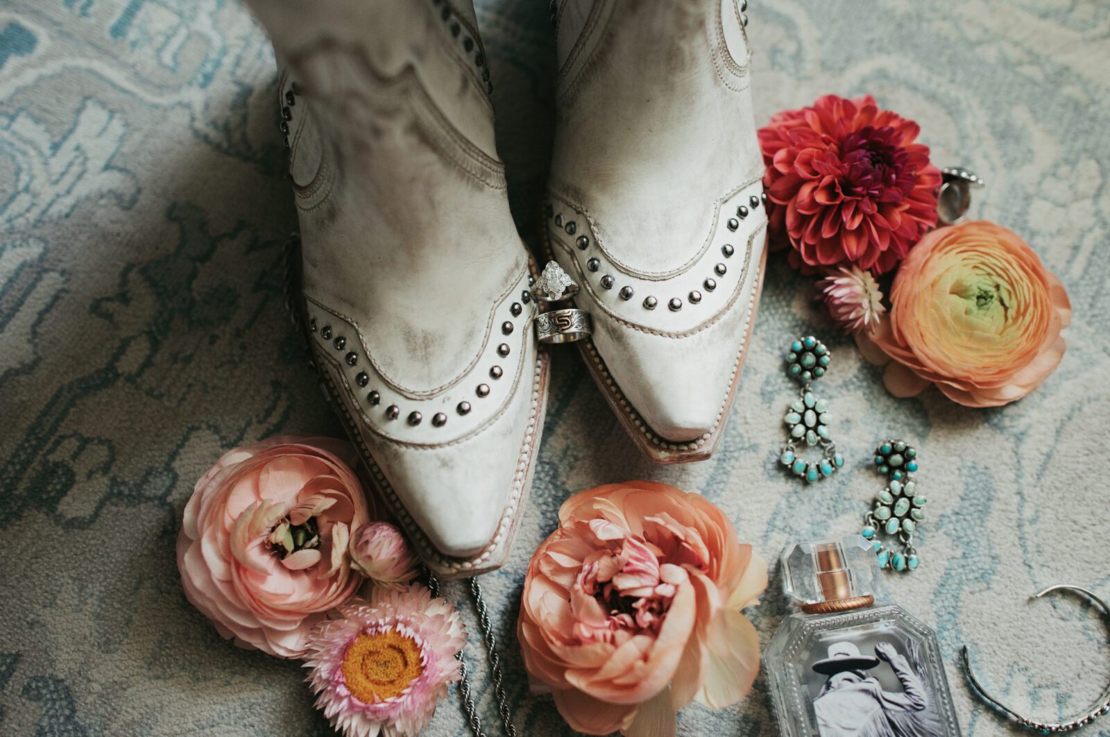 diamond wedding ring on cowgirl boots surrounded by wildflower florals