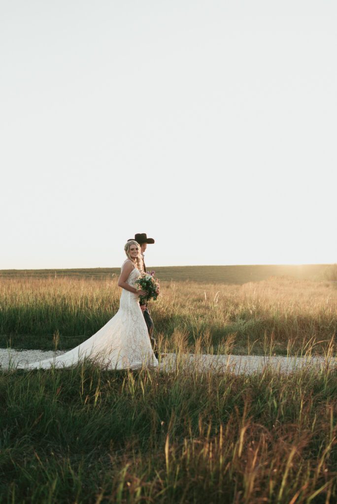 bride and groom walking away at sunset during golden hour wedding photos